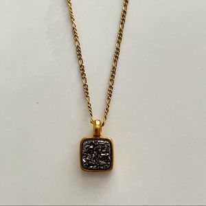 Gold necklace with dark silver crystal